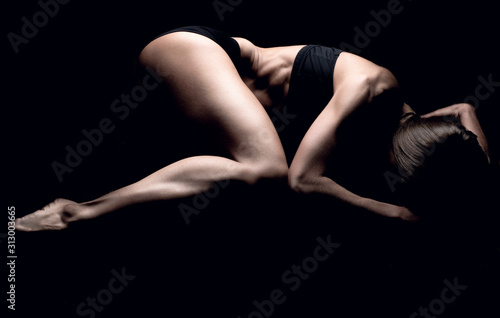 Photo of a young athletic girl made in low key. studio photo of a sports girl