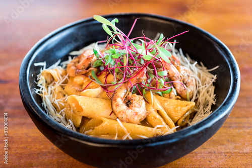 Pasta with shrimp on a wooden table