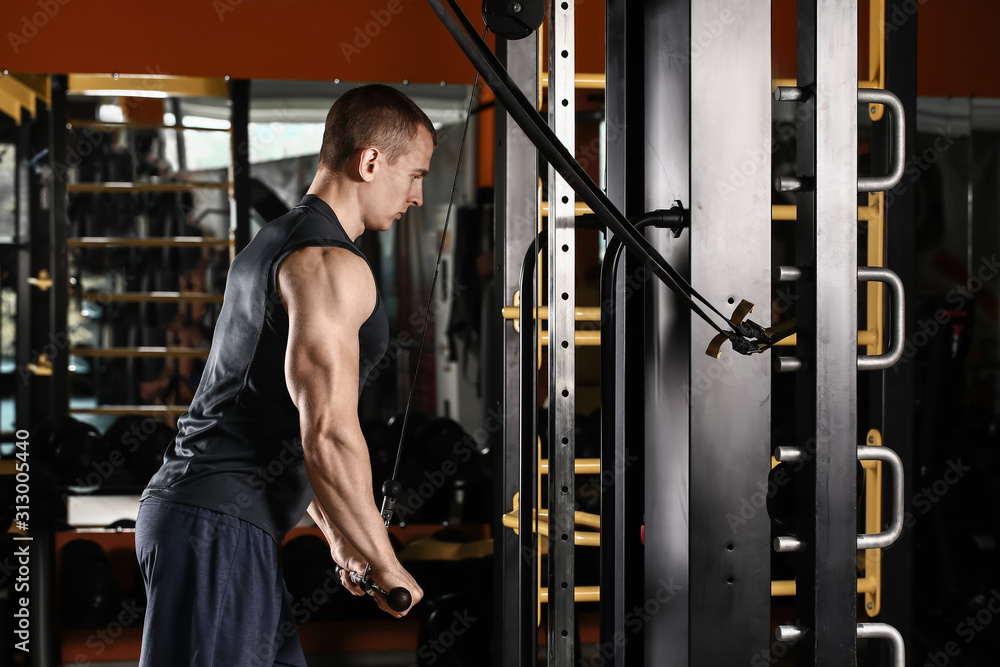 Sporty muscular man training in gym Sporty muscular man training in gym