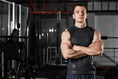 Sporty muscular man in gym