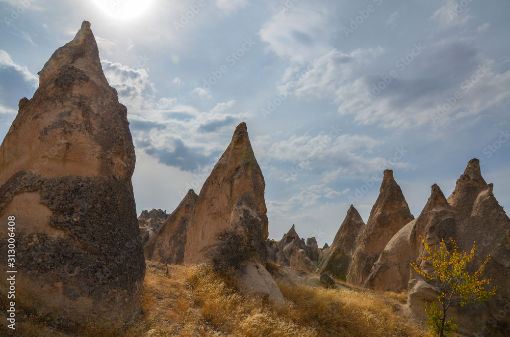 Unique limestone rock pyramids against a cloudy sky, Cappadocia, Turkey