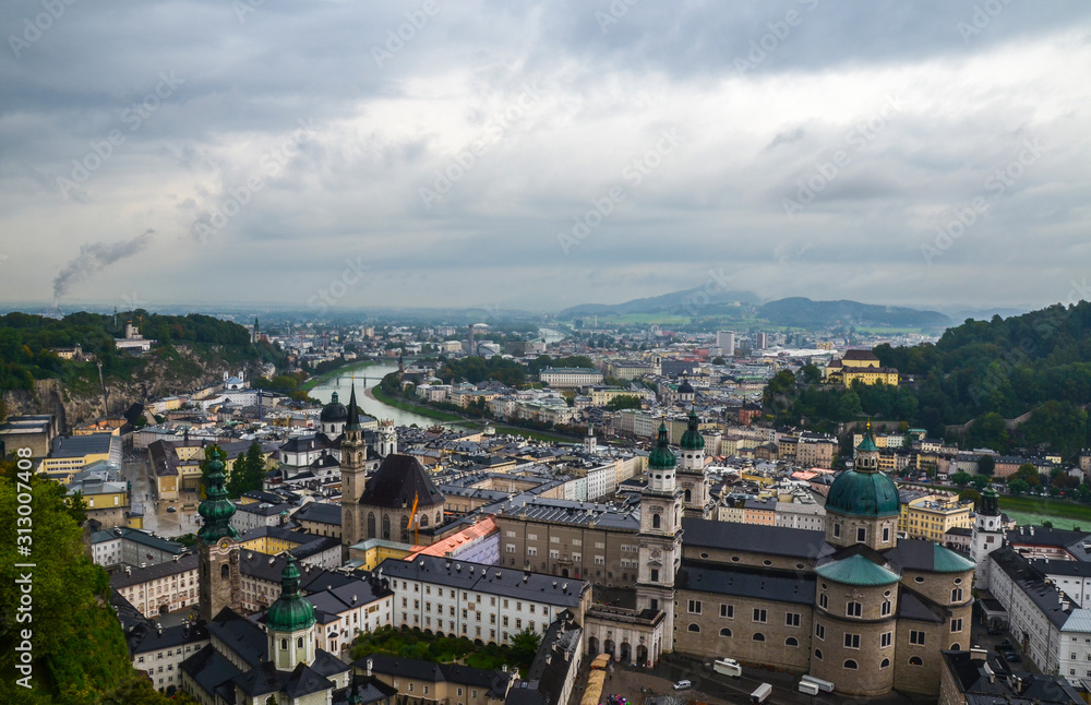 View from Hohensalzburg Castle on the old historic center city of Salzburg including Mirabell palace, the Salzburg cathedral on a rainy day. Austria