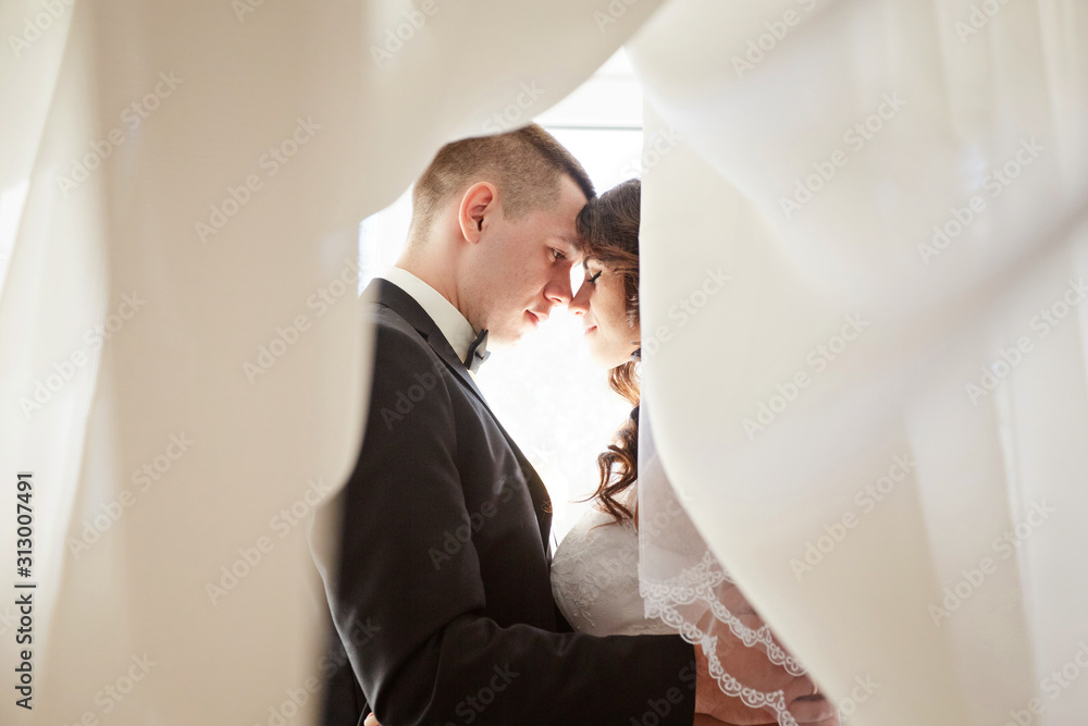 Fototapeta premium The first meeting of the bride and groom on the wedding day. Emotions newlyweds before the wedding ceremony.