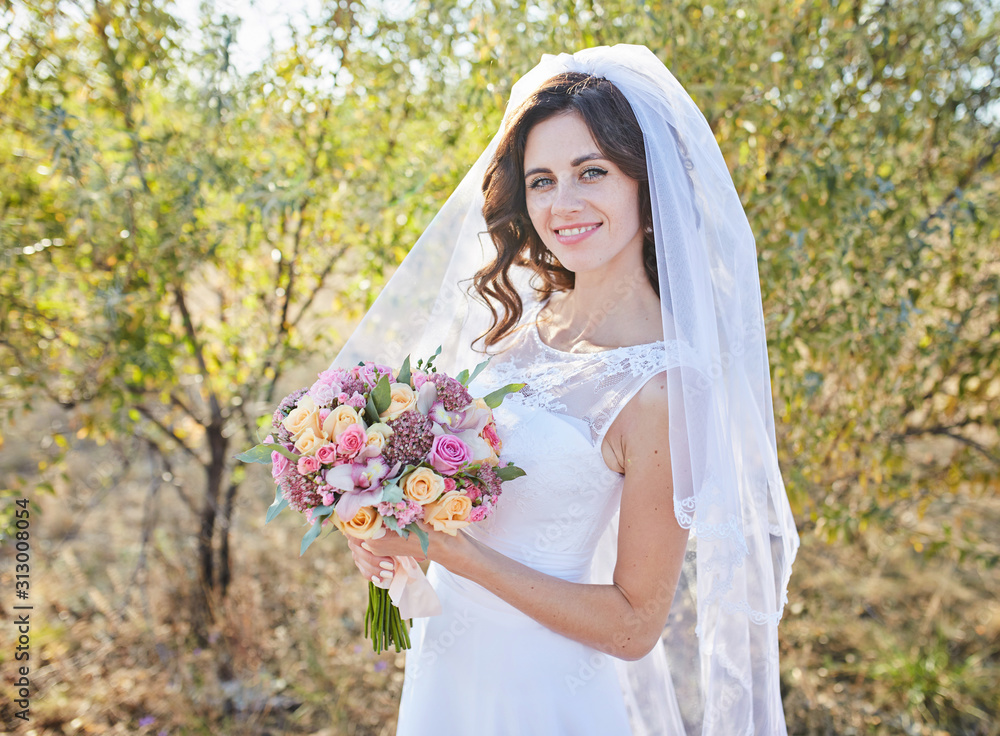 beautiful fabulous happy brunette bride with stylish bouquet