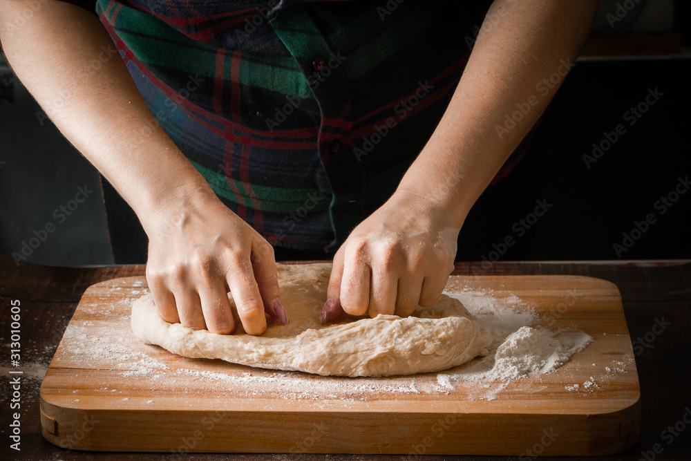 The chef prepares pizza dough