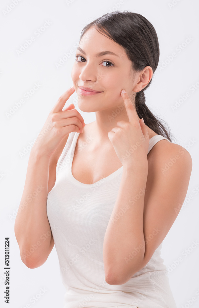 beautiful young woman with clean fresh skin touch own face . facial treatment . cosmetology , beauty and spa . beautiful young woman with clean fresh skin touch own face . facial treatment . cosmetology , beauty and spa .