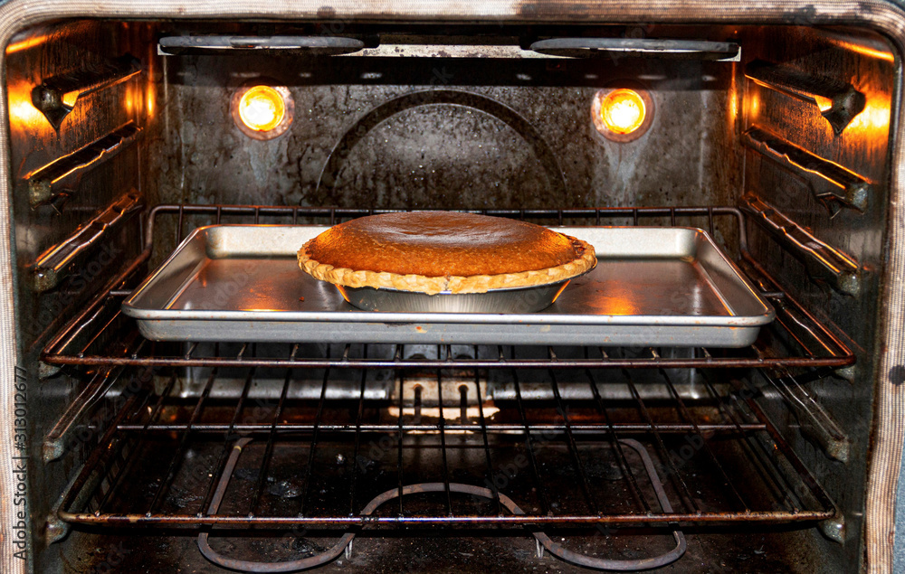 Pumpkin pie cooking in the oven Pumpkin pie cooking in the oven