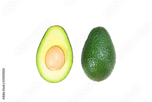 A cut avocado stands alone on a white background