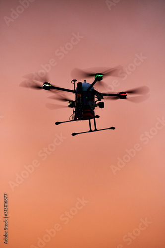Fototapeta Naklejka Na Ścianę i Meble -  inovation drone with automated external defibrilator aed flying in sunset