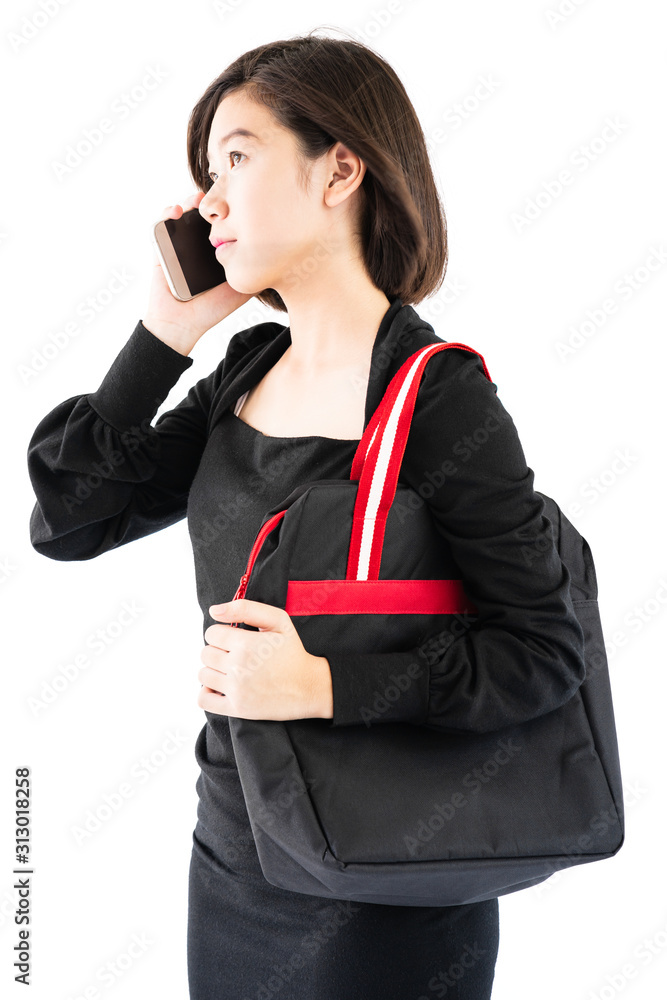 Woman carrying a black shopping bag using cellphone shopping online Woman carrying a black shopping bag using cellphone shopping online