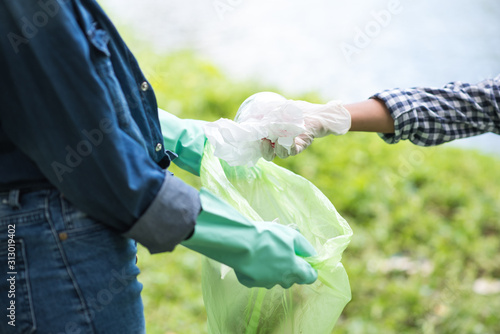 asian women volunteer help garbage collection charity environment river area. Improving environment, closeup. Everyone has to help preserve the ecology on earth. (Environment concept)