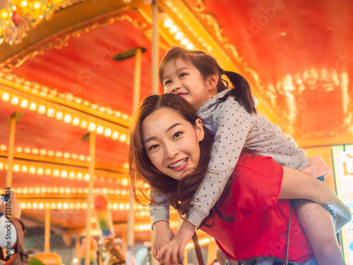 Tablou canvas happy asia mother and daughter have fun in amusement carnival park with farris w