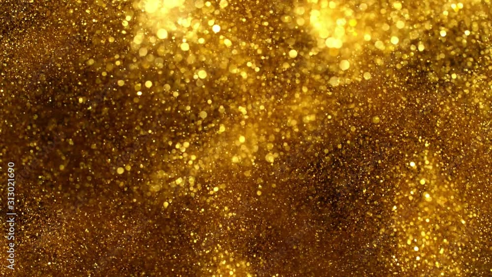 Super slow motion of glittering golden particles on black background. Shallow depth of focus. Filmed on high speed cinema camera, 1000 fps. Super slow motion of glittering golden particles on black background. Shallow depth of focus. Filmed on high speed cinema camera, 1000 fps.
