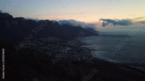 Camps Bay and cloudy mountain range seen from Lion's Head at sunset