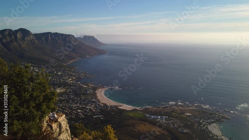 Camps Bay, mountains and open ocean seen from Lion's Head in evening sunlight