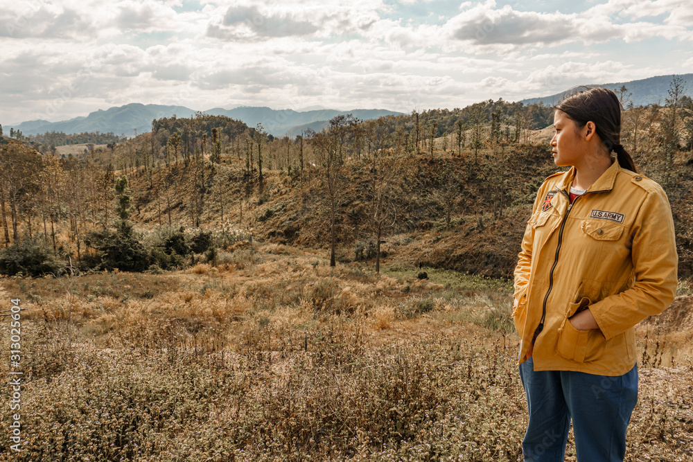 Naklejka premium Girl walks in a tropical forest, in the summer