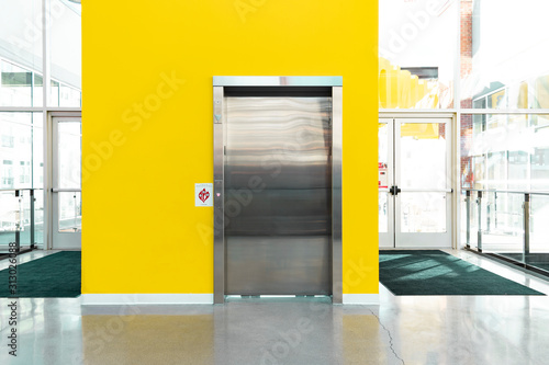 Bright Yellow Wall with Metal Elevator