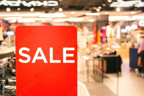 Sale sign in the clothing shop. Shopping sale concept.