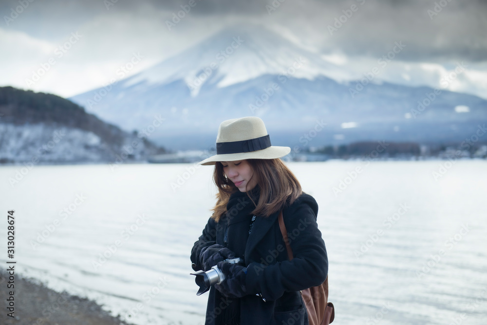 A woman tourist is sightseeing around Mt. Fuji at Lake Kawaguchiko in Japan. A woman tourist is sightseeing around Mt. Fuji at Lake Kawaguchiko in Japan.