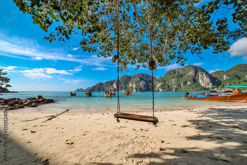 Swing hang from coconut tree over beach, Phi Phi Island, Thailand;