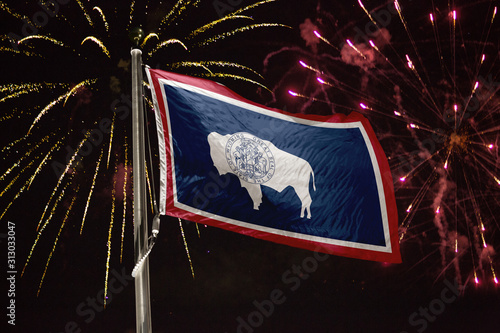 Wyoming flag blowing in the wind at night photo