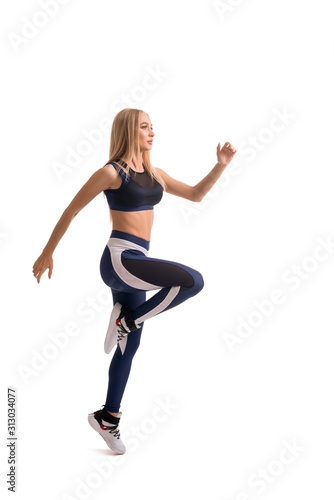 Fototapeta Naklejka Na Ścianę i Meble -  Beautiful fitness model exercising isolated shot