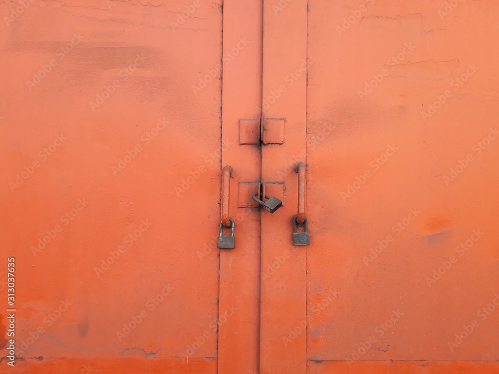 Big orange door background and old black padlock