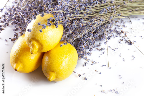 Fresh purple lavender with big three lemons on white isolated background