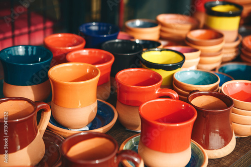 A lot of multi-colored pottery. Hand-made products