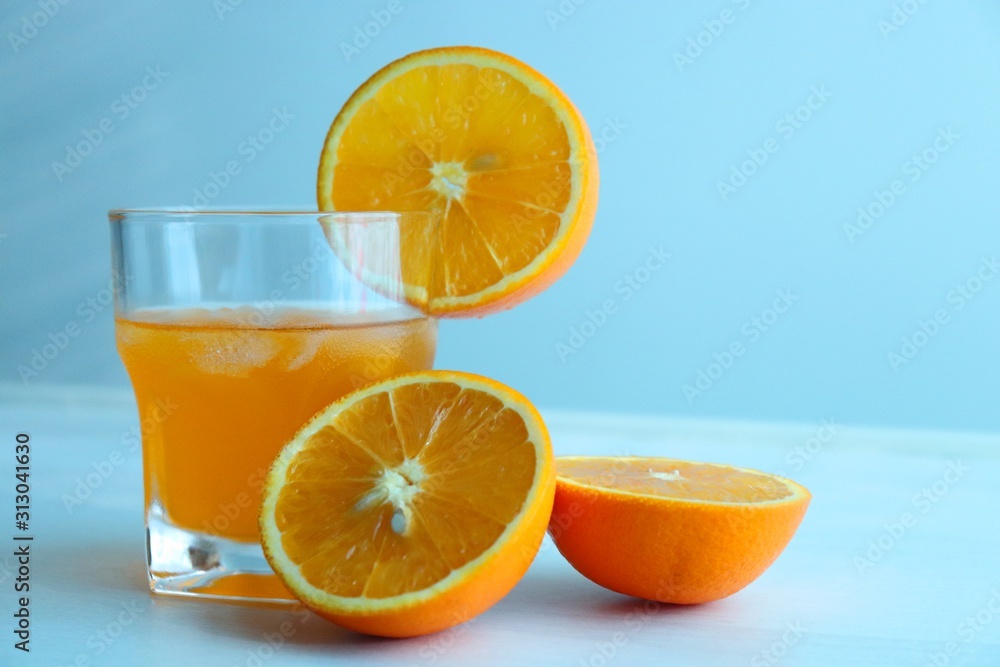 Orange fresh drink, glass of orange juice and ripe citrus fruits on white background Orange fresh drink, glass of orange juice and ripe citrus fruits on white background