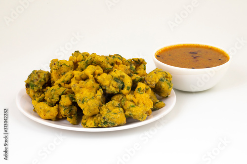 Indian Favourite Street Fried Food Pakora Also Know as Pakoda, Bhajiya, Rava Bhaji, Kanda Bhaji, Pyaz Pakoda, Fried Chillies, Fried Onion Pakora Served with Chutney photo