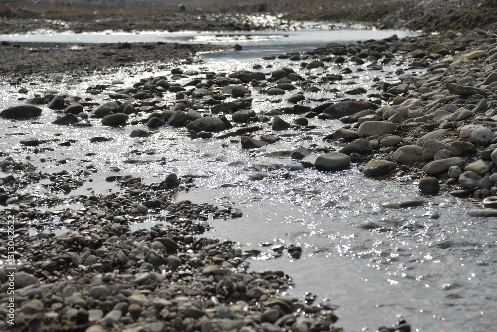 the sea coast in the afternoon with waves and splashes, the sea coast with stones. the sea coast in the afternoon with waves and splashes, the sea coast with stones.