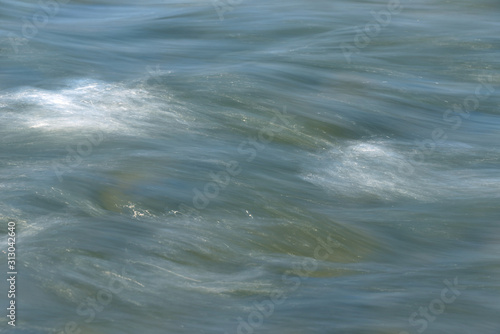 the sea coast in the afternoon with waves and splashes, the sea coast with stones.