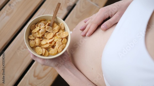 Pregnant Woman Having Tasty And Nutritious Breakfast Cereals.