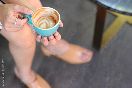 coffee in the morning, cup of cappuccino on wood table in cafe or coffeeshop.