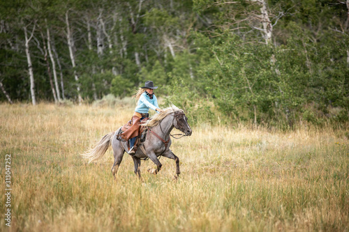Cowgirl On Rocky Mountain Horse