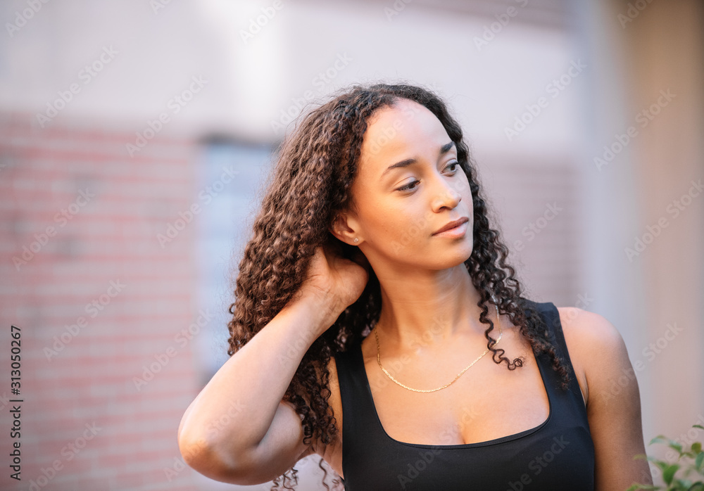 Naklejka premium photo of a black girl with long hair posing and wearing sports clothes. Fitness