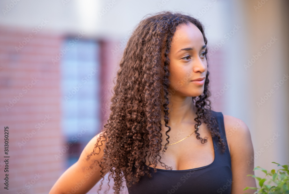 Fototapeta premium photo of a black girl with long hair posing and wearing sports clothes. Fitness