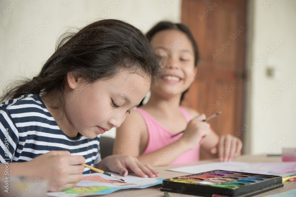 group little girl with brush painting on table in School, education, cut girl painting in at her home. Selective focus and small depth of field, Painting with watercolor, drawing, Creativity concept. group little girl with brush painting on table in School, education, cut girl painting in at her home. Selective focus and small depth of field, Painting with watercolor, drawing, Creativity concept.