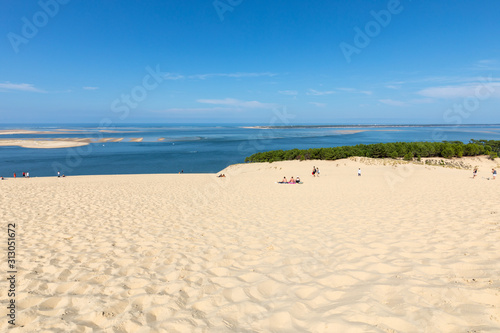 Fototapeta Naklejka Na Ścianę i Meble -  People on the Dune of Pilat, the tallest sand dune in Europe. La Teste-de-Buch, Arcachon Bay, Aquitaine, France