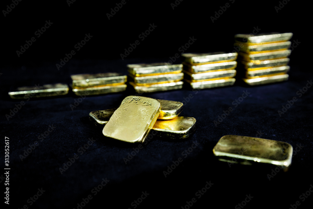 Investment concept of Several pile of gold bars in dark , Fine gold ingot ,Isolated on black background, Selective focus. Financial success, business and wealth concept. Investment concept of Several pile of gold bars in dark , Fine gold ingot ,Isolated on black background, Selective focus. Financial success, business and wealth concept.