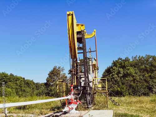 Pumping unit as the oil pump installed on a well photo