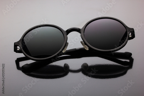 black polarized sunglasses round shape on a dark background
