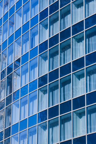 Reflection in blue glass wall of an modern office building