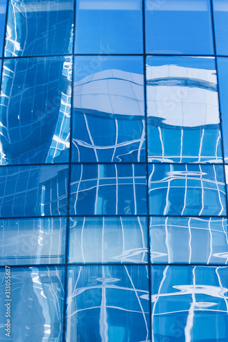 Reflection in blue glass wall of an modern office building