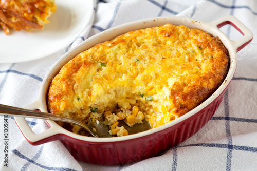 Homemade Cheddar Corn Pudding Casserole, low angle view. Close-up.