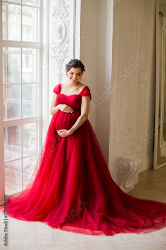 Pregnant woman at red dress © dementevajulia