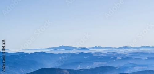 Mountain clean landscape for the background of the website landing page or booklet. Rocks and hills far in the horizon. Colored sky.