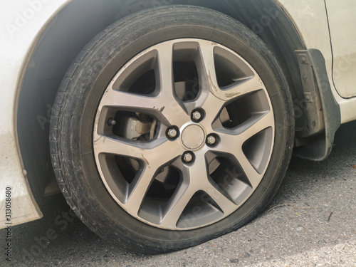 Close up of flat rear tire of a car.