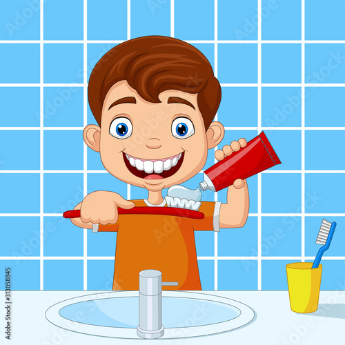 Cute little boy brushing teeth in bathroom